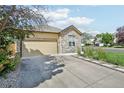 Charming home featuring stone accents and a spacious driveway leading to a two-car garage at 19677 E Vassar Dr, Aurora, CO 80013