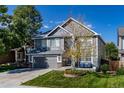 Two-story house with gray siding, landscaped yard, and a two-car garage at 5630 Spruce Ave, Castle Rock, CO 80104