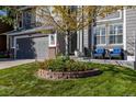 Landscaped front yard with flowers and a brick border at 5630 Spruce Ave, Castle Rock, CO 80104