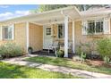 Charming front porch with seating and well-maintained landscaping at 1755 Quince St, Denver, CO 80220