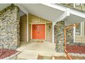 Close-up of the front door and porch area, showcasing stonework and architectural details at 4012 S Newport Way, Denver, CO 80237