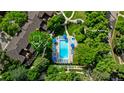 Aerial view of the sparkling community pool and jacuzzi with lounge chairs and umbrellas ready for relaxation at 9400 E Iliff Ave # 292, Denver, CO 80231
