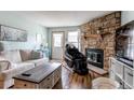 Comfortable living room featuring a stone fireplace, and neutral paint at 19807 Victorian Way, Parker, CO 80138