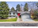 Charming two-story home with blue paint, bright red front door, and well-maintained landscaping at 3722 S Quebec St, Denver, CO 80237