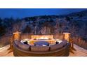 Cozy outdoor patio with fire pit and comfortable seating, perfect for enjoying evenings with mountain views at 8310 Raphael Ln, Littleton, CO 80125