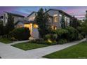 Inviting two-story home with well-maintained landscaping, sidewalk, and lush greenery at 1882 W 67Th Ave, Denver, CO 80221