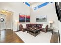 Bright living room with tall ceilings, modern decor, and comfortable leather sectional sofa at 1882 W 67Th Ave, Denver, CO 80221