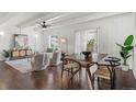 Inviting living and dining area boasts hardwood floors, ceiling fan, and abundant natural light at 9725 E Harvard Ave # 323, Denver, CO 80231