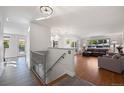 Bright living room with hardwood floors, a staircase, an open layout, and lots of natural light at 703 S Oneida Way, Denver, CO 80224