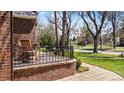 Inviting front porch featuring brick detail and seating area with wrought iron railing at 6023 E 6Th Avenue Pkwy, Denver, CO 80220