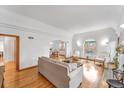 Bright living room with hardwood floors, arched doorway, and ample natural light at 6023 E 6Th Avenue Pkwy, Denver, CO 80220