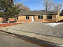 Brick ranch home with landscaped yard and gravel driveway at 914 Quari Ct, Aurora, CO 80011