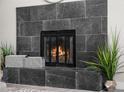 Modern fireplace with dark tile surround at 914 Quari Ct, Aurora, CO 80011