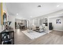 Bright living room with hardwood floors, modern fireplace, and large windows at 914 Quari Ct, Aurora, CO 80011