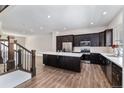 Spacious kitchen with dark cabinets, stainless steel appliances, and a white quartz countertop island at 12336 W 52Nd Ave, Wheat Ridge, CO 80033