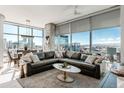 Comfortable living room boasting floor-to-ceiling windows and stylish decor with captivating cityscape views at 1700 Bassett St # 1808, Denver, CO 80202