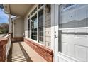 Inviting front porch with brick accents and a well-maintained entrance at 3205 E 102Nd Pl, Thornton, CO 80229