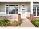 Inviting front entrance with brick accents and a charming welcome mat at 3205 E 102Nd Pl, Thornton, CO 80229
