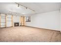Finished basement features carpeted floors, a fireplace, and recessed lighting at 11196 E Baltic Dr, Aurora, CO 80014