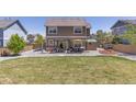 Wide backyard featuring a stone patio, lawn, hot tub, and a privacy fence at 217 Peabody St, Castle Rock, CO 80104