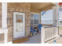 Inviting front porch with chairs, plants, and a 'Welcome' sign, creating a warm and friendly entrance to the home at 217 Peabody St, Castle Rock, CO 80104