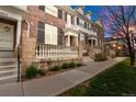 Street view of well-maintained townhomes showcasing brick exteriors and front patios at 3818 S Dallas St, Aurora, CO 80014