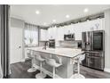 Modern kitchen with stainless steel appliances, granite countertops, and a functional island at 3818 S Dallas St, Aurora, CO 80014