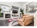 Stylish living room boasts a modern fireplace, recessed lighting, and an open layout at 3818 S Dallas St, Aurora, CO 80014