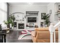 Bright and airy living room features an inviting fireplace and a contemporary design at 3818 S Dallas St, Aurora, CO 80014