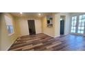 Open-concept living room with updated flooring, leading to an adjacent kitchen space at 1940 Quince St, Denver, CO 80220