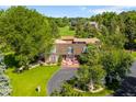 Beautiful brick home with an expanse of manicured lawn and mature trees at 4181 S Colorado Blvd, Cherry Hills Village, CO 80113