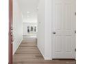 Hallway featuring hardwood floors leading to bright, open living area at 6554 N Malta St, Aurora, CO 80019