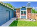 Close up of the home's entrance and facade showing the brickwork and modern color scheme at 9446 W Wagon Trail Cir, Littleton, CO 80123