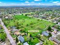 Aerial view of neighborhood including Washington Heights Park nearby the residential area with a field and parkway at 431 N Harlan St, Lakewood, CO 80226