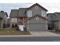 Charming two-story home featuring a well-manicured front yard and attached two-car garage at 486 W 116Th Pl, Northglenn, CO 80234