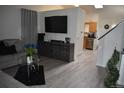 Comfortable living room showcases hardwood floors, modern decor and open layout to the kitchen at 486 W 116Th Pl, Northglenn, CO 80234