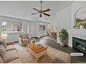 Virtually staged living room with fireplace and seating area at 7770 W 90Th Dr, Broomfield, CO 80021