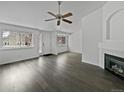 Bright living room with gray floors and a fireplace at 7770 W 90Th Dr, Broomfield, CO 80021