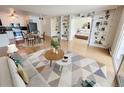 Open-concept living space with a dining area and adjacent bedroom separated by bookshelves at 715 S Alton Way # 10A, Denver, CO 80247