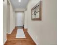 Bright entryway with hardwood floors and mirror at 4439 Mcmurdo Ct, Castle Rock, CO 80108