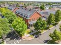 A beautiful aerial view of a red brick home nestled in a lush, green, landscaped neighborhood at 11791 Bradburn Blvd, Westminster, CO 80031