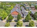 Expansive aerial view showing a red brick home surrounded by mature trees in a neighborhood setting at 11791 Bradburn Blvd, Westminster, CO 80031