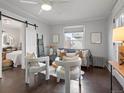 Bright living room with hardwood floors, comfy seating, and a view into the bedroom at 65 N Logan St # B4, Denver, CO 80203