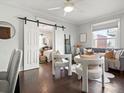 Living room features hardwood floors, a cozy couch, and sliding barn doors to the bedroom at 65 N Logan St # B4, Denver, CO 80203