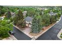 Stunning aerial view of home surrounded by lush trees, showcasing the property's curb appeal and neighborhood at 16416 E Powers Pl, Centennial, CO 80015