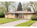Ranch-style home showcasing a lovely front yard and a convenient driveway leading to an attached garage at 9000 W 4Th Pl, Lakewood, CO 80226