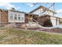 Two-story brick home with yellow front door and landscaping at 5385 Camargo Rd, Littleton, CO 80123