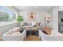 Bright living room featuring neutral tones, modern decor, a stylish rug, and ample natural light at 742 Hanover St, Aurora, CO 80010