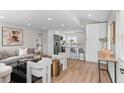Bright living space with modern decor, light hardwood floors, and open floor plan with bar seating at 742 Hanover St, Aurora, CO 80010
