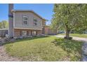 Charming two-story home with a well-manicured lawn, brick accents and mature shade trees providing curb appeal at 8438 Prairie Clover Way, Parker, CO 80134